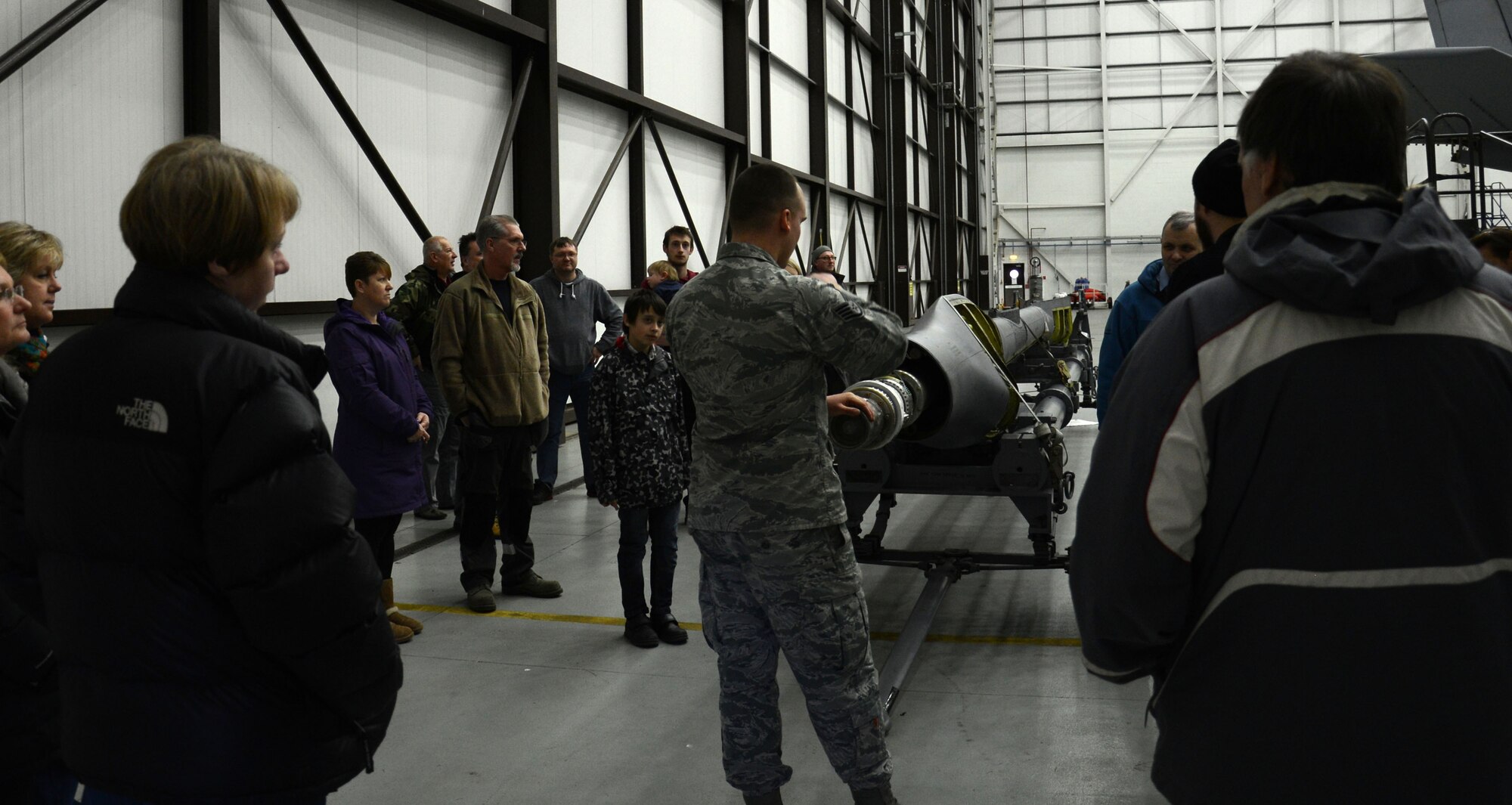 U.S. Air Force Staff Sgt. Joseph Weese, center, 100th Maintenance Squadron Aerospace Maintenance craftsman from Englewood, Fla., gives an informative brief on a boom during a Civilian Appreciation Day tour Feb. 27, 2015, on RAF Mildenhall, England. The tour included the fuels sections tour, an aircraft viewing, mobility bag demonstration, a military working dog display and a fire truck viewing. (U.S. Air Force photo by Gina Randall/Released)