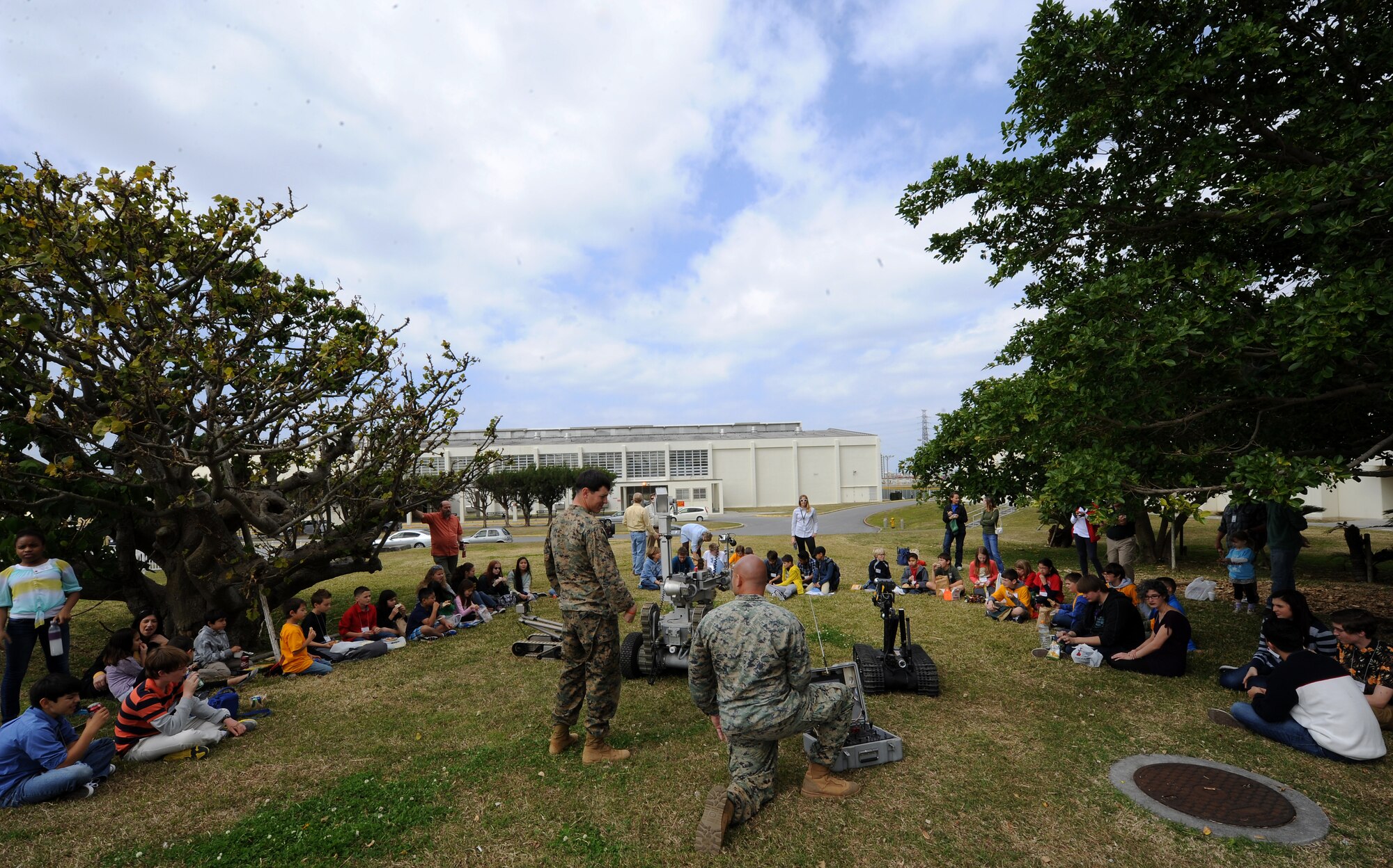 U.S. Marine Corps Sgt. Larry Hicks and Staff Sgt. Paul Mead, Marine Corps Base Explosive Ordnance Disposal EOD technicians, give Department of Defense Dependent Schools students a robotics demonstration on U.S. Marine Corps Camp Foster, Japan, Feb. 20, 2015. The Marines gave the presentation as part of an island-wide robotics competition between students from DoDDS schools around the island and encouraged them to pursue their interests in science, technology, engineering and math. (U.S. Air Force photo by Airman 1st Class Zade C. Vadnais)