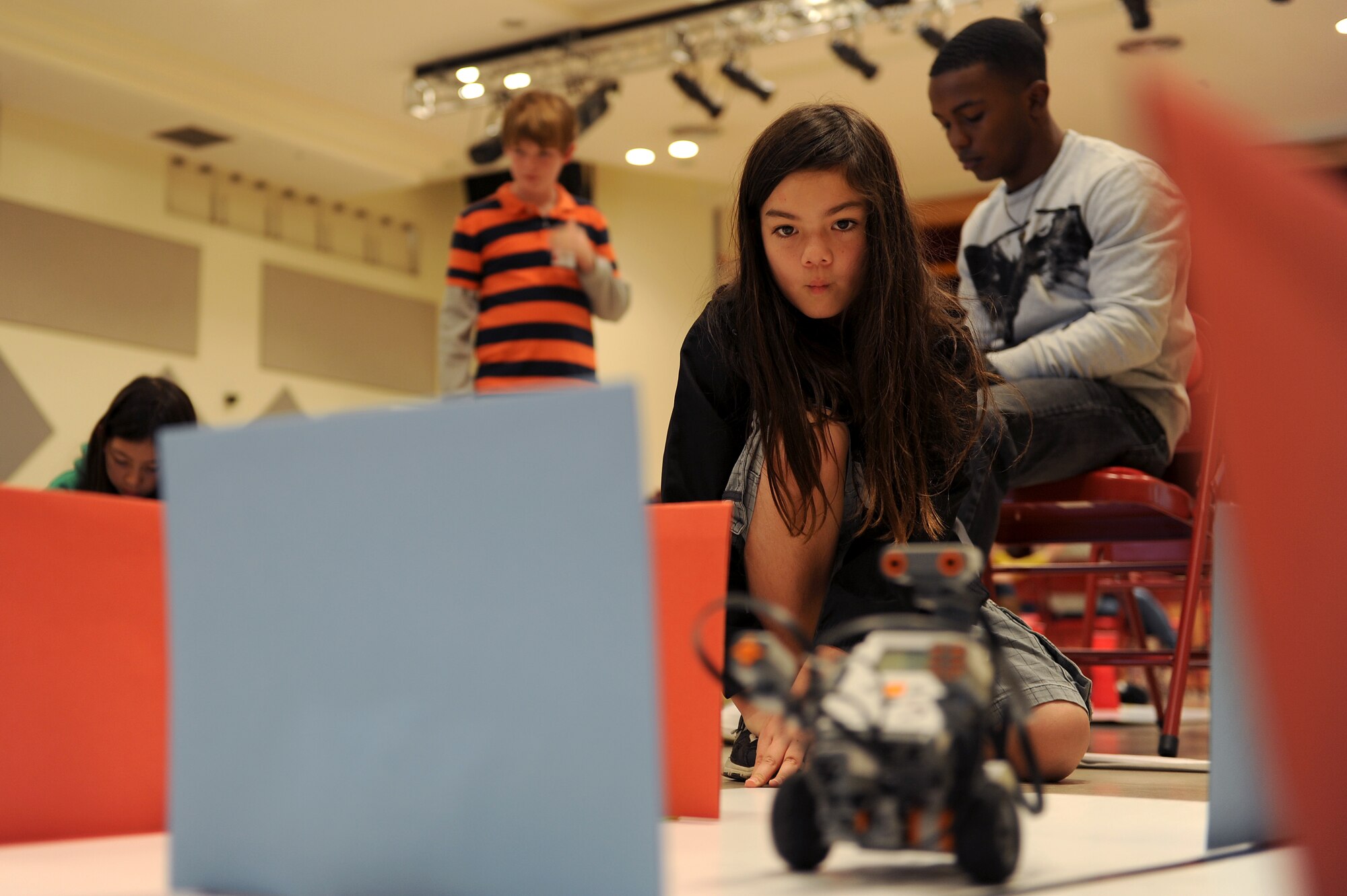 Caitlin Yasuki, a Kadena Elementary School student, watches to see if she successfully programmed her robot to navigate an obstacle course during an island-wide robotics competition on U.S. Marine Corps Camp Foster, Japan, Feb. 20, 2015. KES students practiced for several weeks before the competition, learning to use programming software and competing amongst themselves to see who would represent their school at the island-wide competition. (U.S. Air Force photo by Airman 1st Class Zade C. Vadnais)