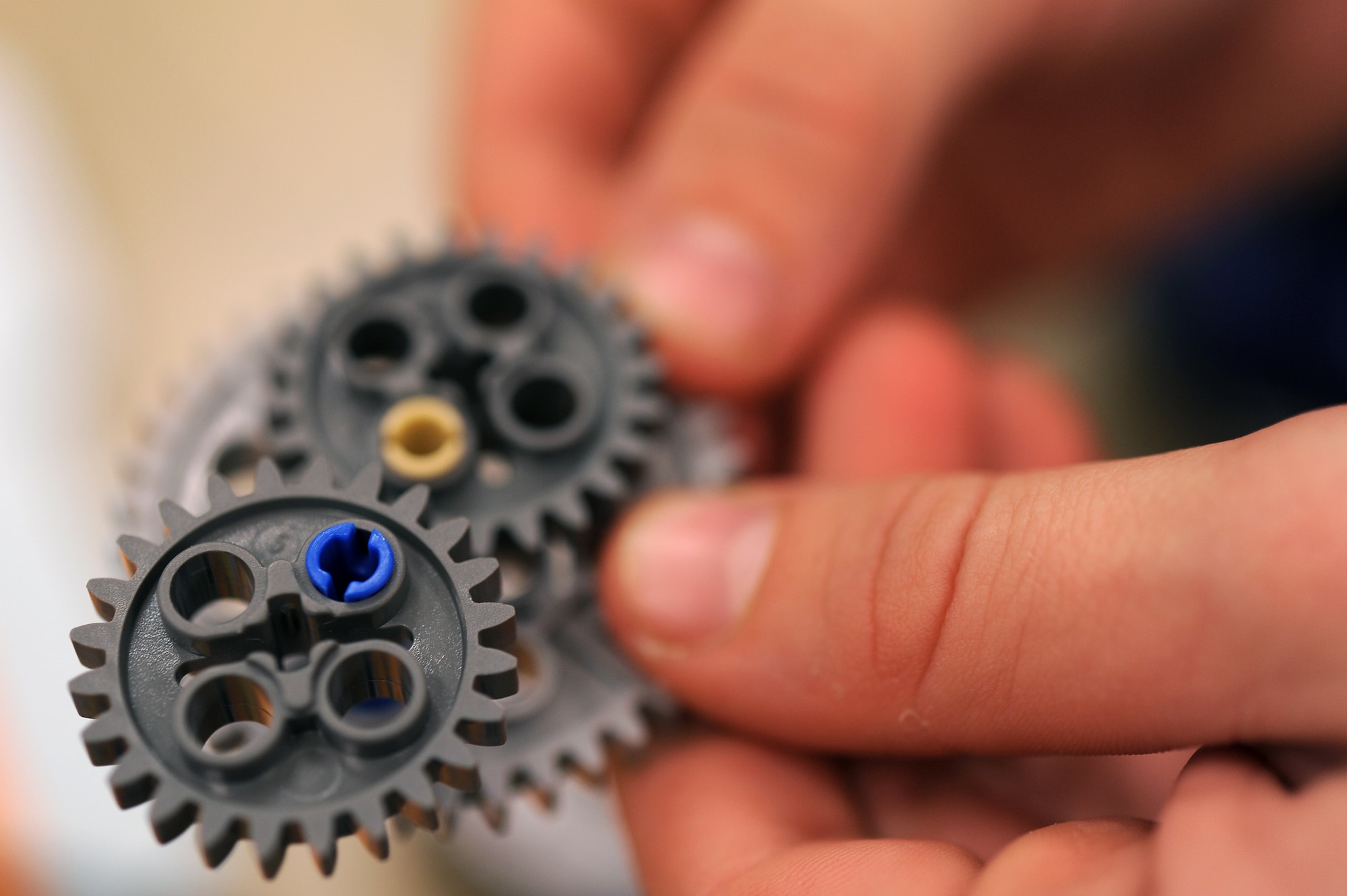 A Kadena Elementary School student connects a series of gears while assembling a robot on Kadena Air Base, Japan, Feb. 11, 2015. Kadena Elementary School students built robots and learned to program them in order to compete in an island-wide robotics competition on U.S. Marine Corps Camp Foster, Japan. (U.S. Air Force photo by Airman 1st Class Zade C. Vadnais)