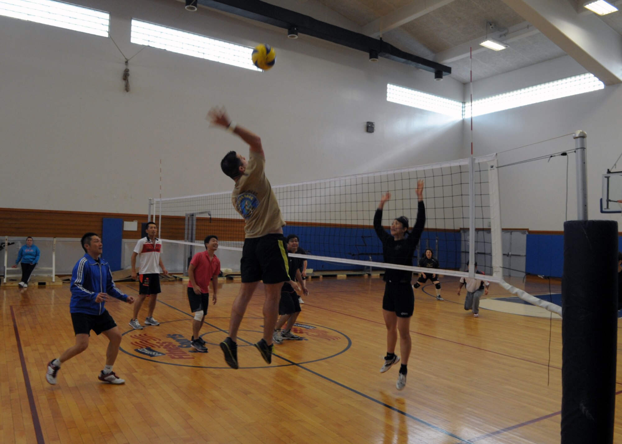 Adam Bearden soars for a spike during an invitational volleyball tournament Feb. 28, 2015, at Kadena Air Base, Japan. Members of the Company Grade Officer Council and Airmen Committed to Excellence invited two Japanese teams to the base for a day of sportsmanship and camaraderie, and Bearden played with the Japan Air Self-Defense team from Naha Air Base during one of the games. (U.S. Air Force photo by Tim Flack)