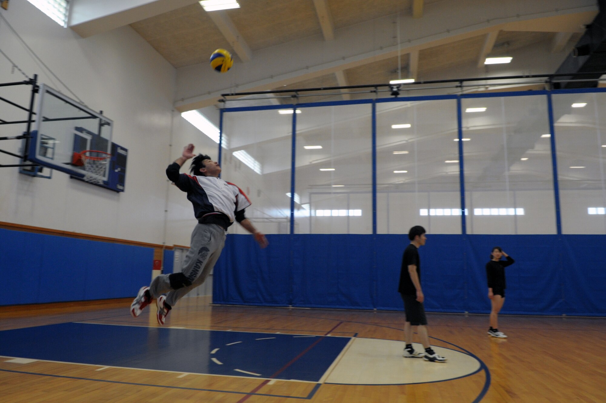Katsuhiko Nakachi, chief of directors for the Okinawa City Volleyball Association, jump serves during an invitational volleyball tournament Feb. 28, 2015, at Kadena Air Base, Japan. Members of the Company Grade Officer Council and Airmen Committed to Excellence invited two Japanese teams to the base for a day of sportsmanship and camaraderie. (U.S. Air Force photo by Tim Flack)