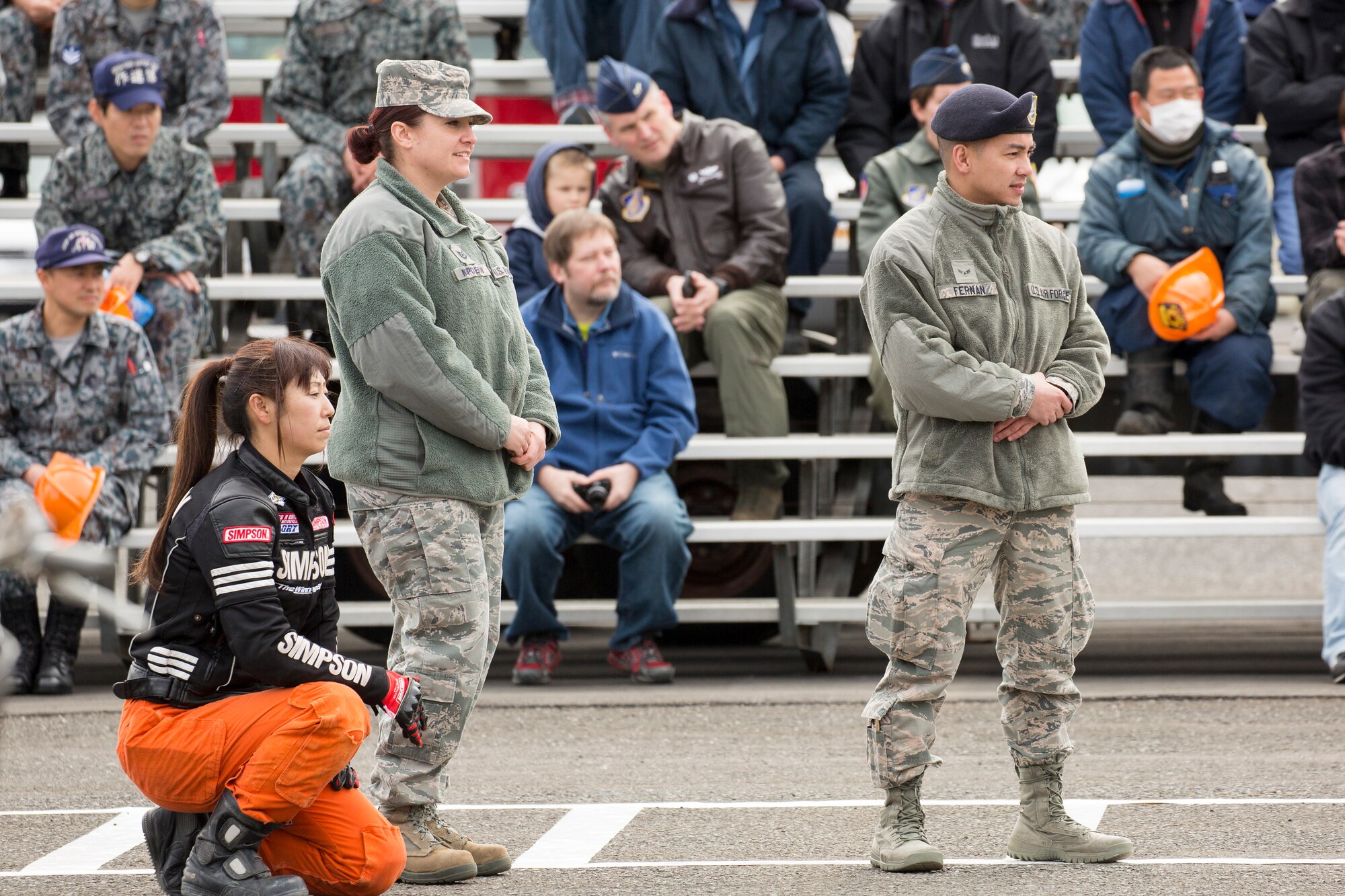 (Left to right) Tech. Sgt. Laury Napoleoni, 374th Airlift Wing Safety ground safety manager, and Airman 1st Class Lawrence Fernan, 374th Security Forces Squadron patrolman, watch an in-your-face car accident demonstration during the safety festival at Yokota Air Base, Japan, March 6, 2015. The Fussa police station sponsored a traffic safety demonstration for Yokota residents during the fest. The event demonstrated hairy moment in car accidents. (U.S. Air Force photo by Osakabe Yasuo/Released)