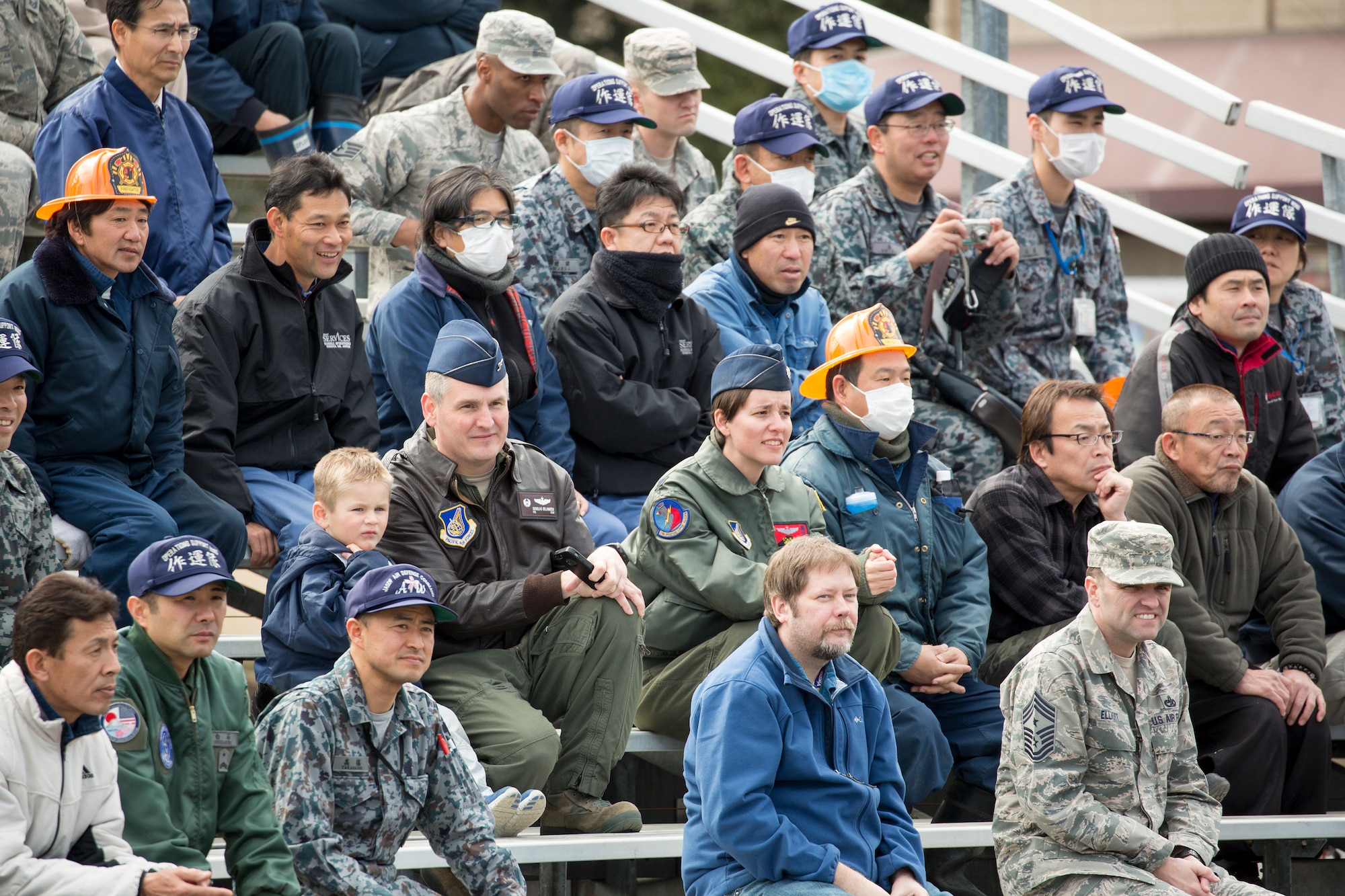 Audience members watch the traffic safety demonstration by stunt project team “Super Drivers” during the safety festival at Yokota Air Base, Japan, March 6, 2015. The event demonstrated hairy moments in car accidents. (U.S. Air Force photo by Osakabe Yasuo/Released)