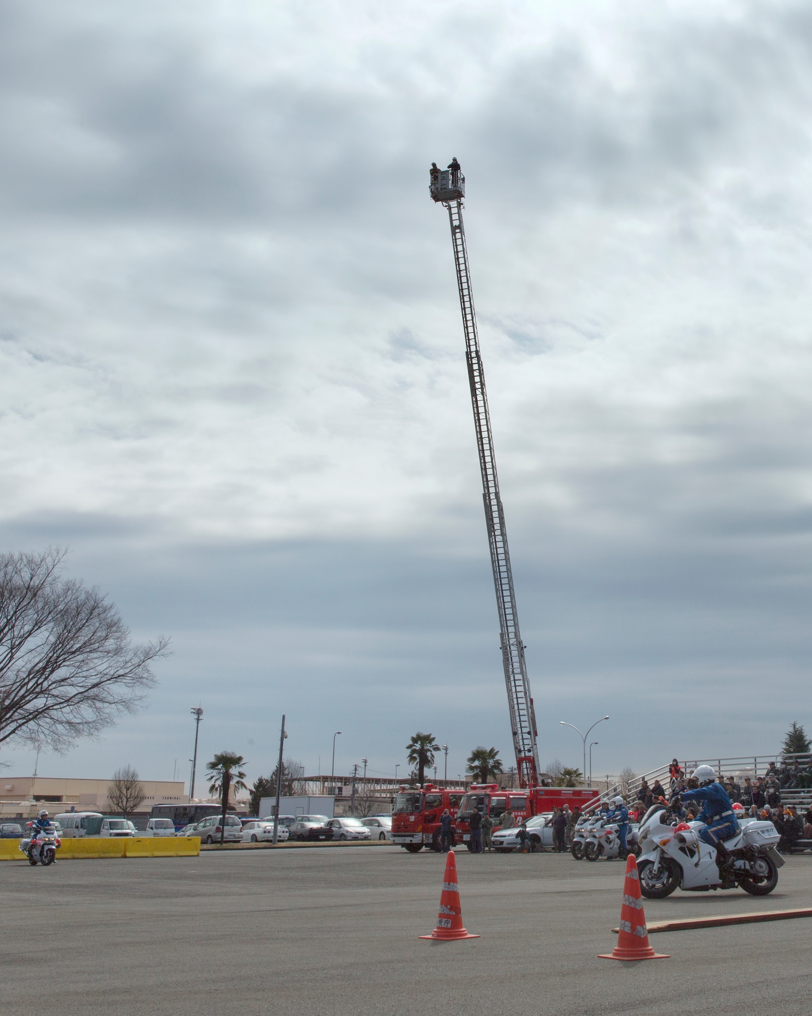 Team Yokota members participate in the safety festival at Yokota Air Base, Japan, March 6, 2015. The 374th Airlift Wing Safety Office provided Yokota residents  with various events such as the Tokyo Metropolitan Police Department motorcycle unit demonstration, traffic safety demonstration, earthquake and smoke house, firefighting experience, fire ladder trucks experience,  374th Security Forces Squadron patrol vehicle ride, seatbelt simulator and child car seat checks. (U.S. Air Force photo by Osakabe Yasuo/Released)  