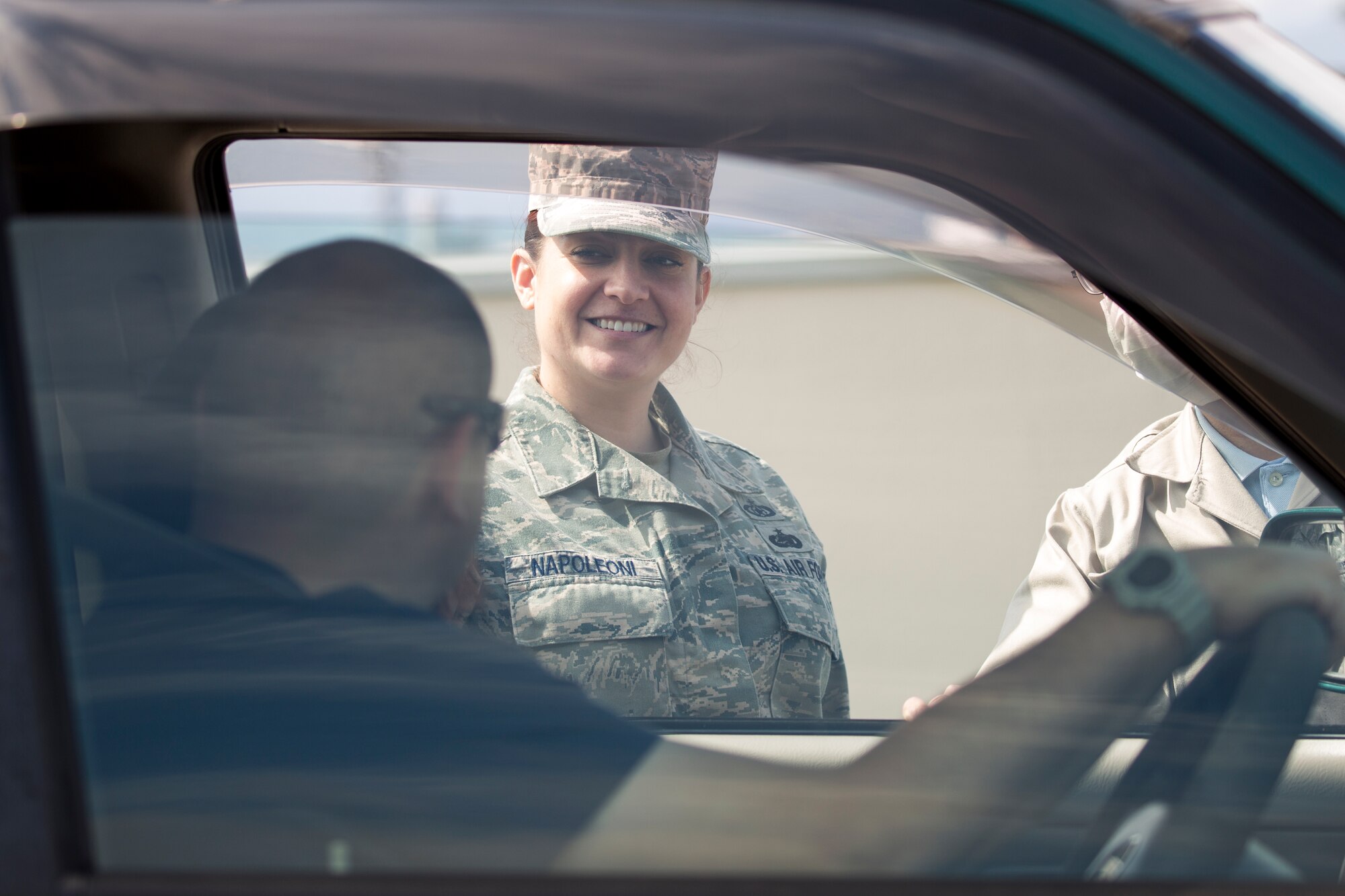 Tech. Sgt. Laury Napoleoni, 374th Airlift Wing Safety ground safety manager, talks to a driver during a safety week promotion at Yokota Community Center, March 4, 2015.  The 374 Airlift Wing Safety held safety week from March 2 to 6. The safety week was designed to improve personal and wingman’s safety. (U.S. Air Force photo by Osakabe Yasuo/Released)