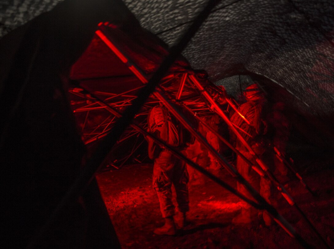 Marines set up their forward command element’s combat operations center during a night movement March 5 during Dragon Fire Exercise 15-2 at Pohakuloa Training Area. Marines use red lights, instead of white, at night to avoid giving away their position. Night movements provide Marines with cover and concealment and provide good practice for setting up combat operation centers. The Marines are with Headquarters Battery, 12th Marine Regiment, 3rd Marine Division, III Marine Expeditionary Force.