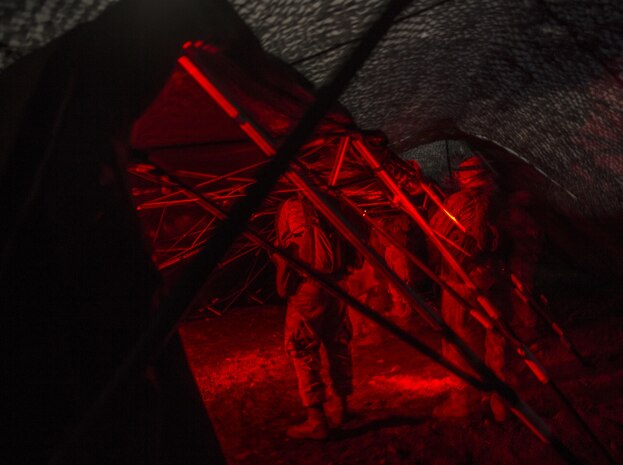 Marines set up their forward command element’s combat operations center during a night movement March 5 during Dragon Fire Exercise 15-2 at Pohakuloa Training Area. Marines use red lights, instead of white, at night to avoid giving away their position. Night movements provide Marines with cover and concealment and provide good practice for setting up combat operation centers. The Marines are with Headquarters Battery, 12th Marine Regiment, 3rd Marine Division, III Marine Expeditionary Force.