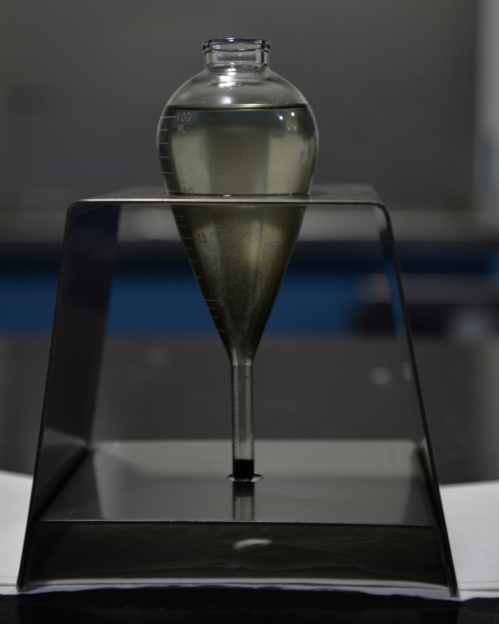 A centrifuge tube sits in the 15th Maintenance Squadron's Nondestructive Inspection Lab, on Joint Base Pearl Harbor-Hickam, Hawaii, March 6, 2015. The centrifuge tube is used to check the concentration of the iron particles in the magnetic particle compound. This compound is used in the magnetic particle inspection process to check aircraft parts and components for defects.( U.S. Air Force photo by Tech. Sgt. Aaron Oelrich/Realeased)