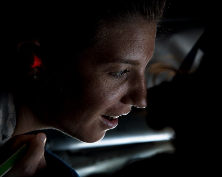 Capt. Nicole Ward, 15th Medical Group, watches a F-16 Fighting Falcon from the 162nd Fighter Wing, Arizona Air National Guard, receive fuel from a KC-135R Stratotanker from the 96th Air Refueling Squadron, during the Hawaii Air National Guard exercise Sentry Aloha over Hawaii, March. 5, 2015. Ward was one of eight Airmen hand selected for a incentive flight on the KC-135R. (U.S. Air Force photo by Tech. Sgt. Aaron Oelrich/Released)