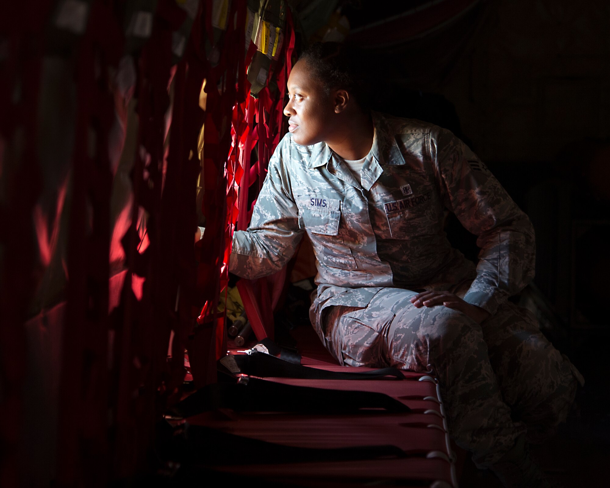 Senior Airman Alicia Sims from the 15th Medical Group looks out the window of a KC-135R Stratotanker on Joint Base Pearl Harbor-Hickam, Hawaii, March. 5, 2015. Sims was one of eight Airmen hand selected for an incentive flight on the KC-135R. (U.S. Air Force photo by Tech. Sgt. Aaron Oelrich/Released)