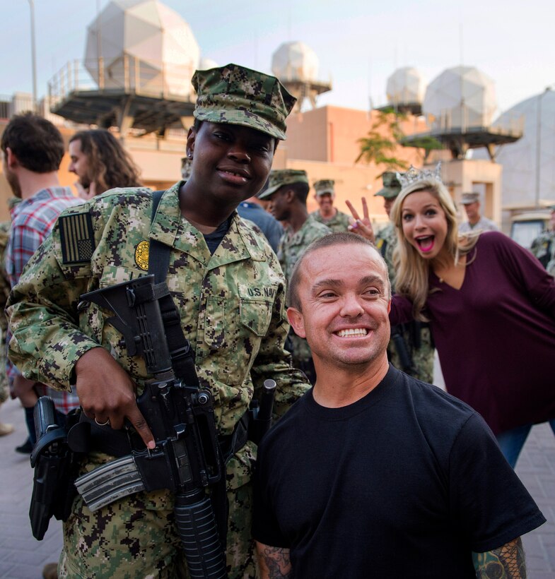 Television host and actor Jason “Wee Man” Acuna, poses with a sailor after a USO show at Naval Support Activity Bahrain, March 4, 2015.