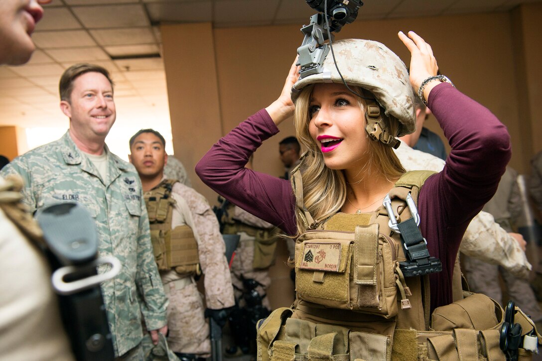 Miss America Kira Kazantsev puts on some Marine field gear after a USO concert at Naval Support Activity Bahrain, March 4, 2015.