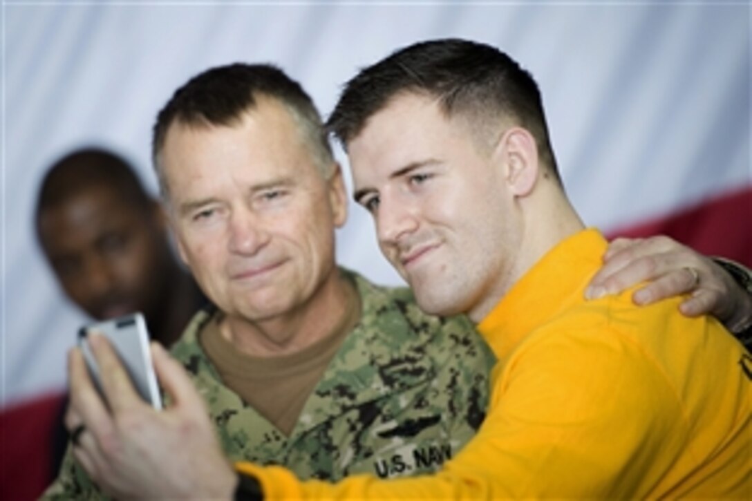 U.S. Navy Adm. James Winnefeld, vice chairman of the Joint Chiefs of Staff, poses for a selfie with a sailor during his visit to the aircraft carrier USS Carl Vinson in the Arabian Gulf, March 5, 2015. Winnefeld was visiting the ship as part of the spring USO tour. 