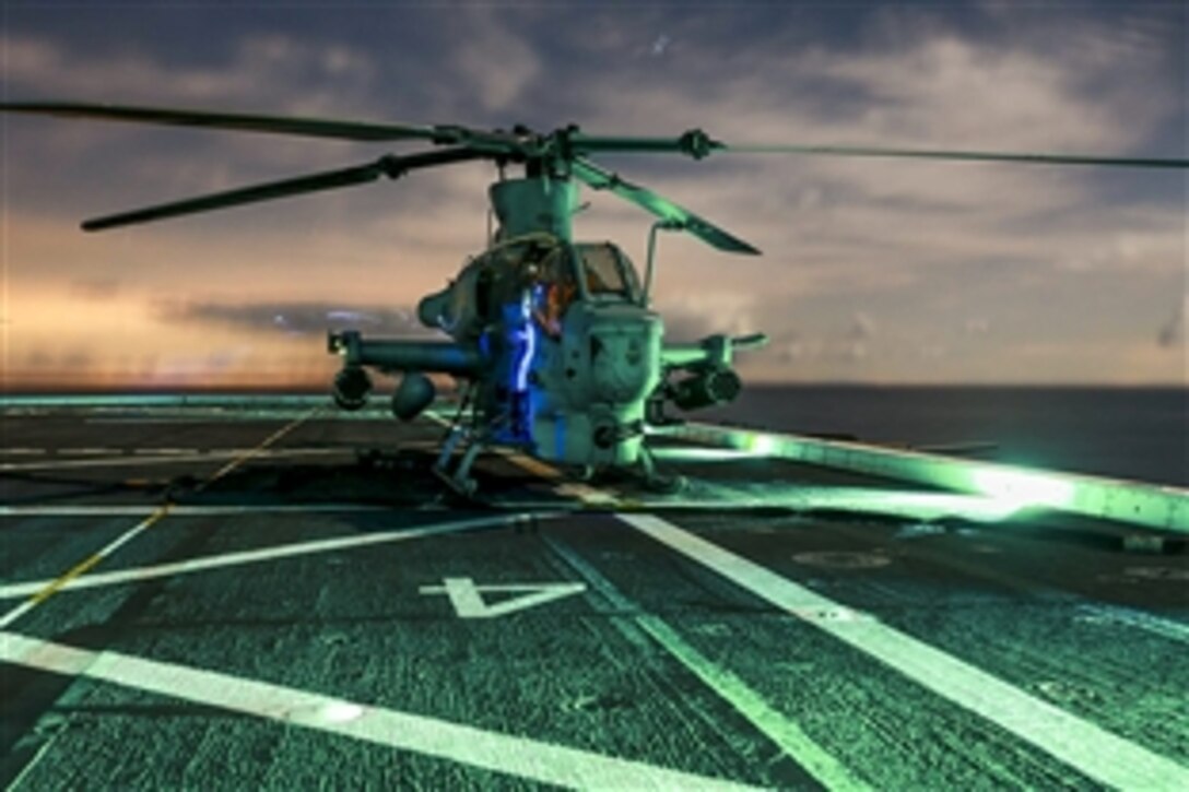 Marines perform maintenance checks on an AH-1Z Viper helicopter aboard the USS Anchorage off the coast of San Diego, March 2, 2015. The pilots and helicopter are assigned to the Marine Medium Tiltrotor Squadron 161, 15th Marine Expeditionary Unit. They are conducting an amphibious squadron and Marine expeditionary unit integration training exercise.  