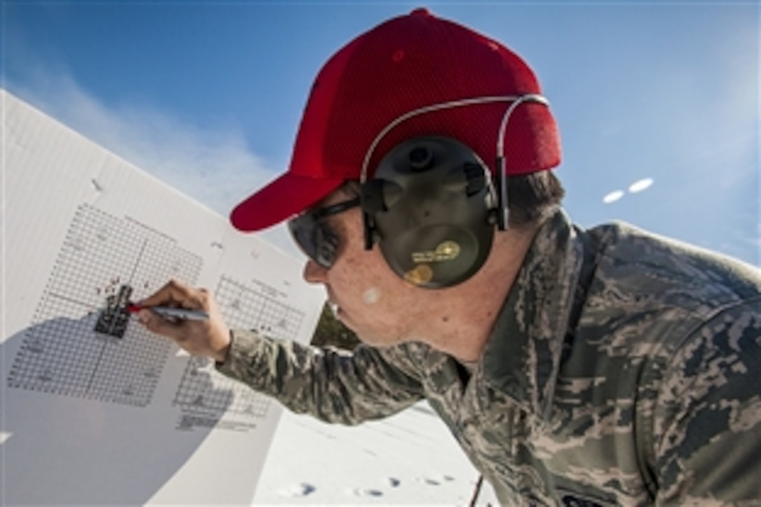 Air Force Senior Airman Raymond J. Buckno examines target groupings during M4 Carbine qualification on Joint Base McGuire-Dix-Lakehurst, N.J., March 8, 2015. Buckno is assigned to the 108th Wing, New Jersey Air National Guard.
