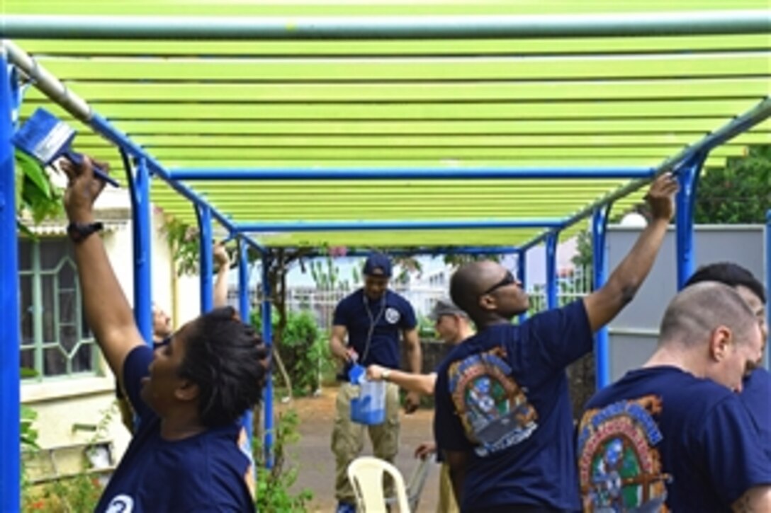 Sailors assigned to the guided missile destroyer USS Oscar Austin help paint an archway during a community service event at the SOS Children's Village in Port Louis, Mauritius, March 1, 2015. The Oscar Austin is conducting naval operations in the U.S. 6th Fleet area of responsibility.