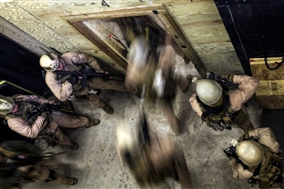 A Marine fire team enters a room after throwing in a flash bang during a close-quarters tactics training event at Stone Bay on Marine Corps Base Camp Lejeune, N.C., March 6, 2015. The Marines are assigned to the 2nd Force Reconnaissance Detachment 6.