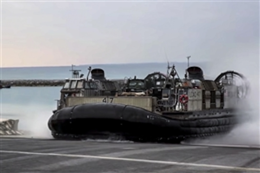 U.S. Navy Chief Petty Officer Philip Phillips pilots a landing craft air cushion as it transports Marines and equipment from ship to shore near Okinawa, Japan. The vehicles are assigned to Naval Beach Unit 7. The Marines are assigned to the 31st Marine Expeditionary Unit and are currently conducting Spring Patrol 2015.