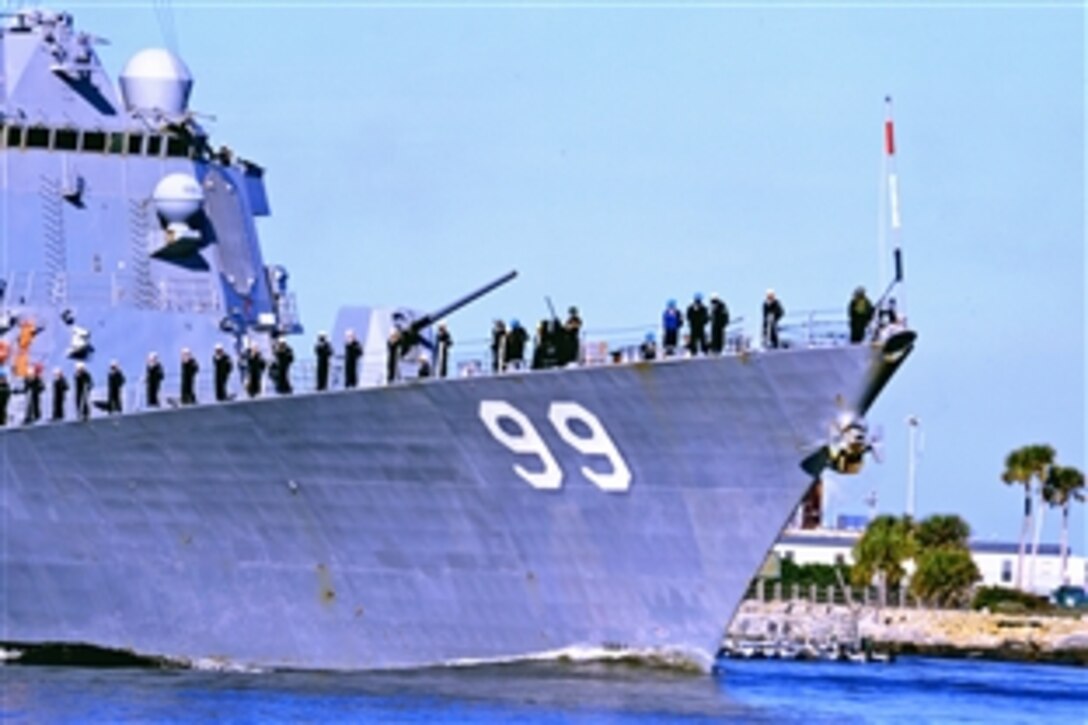 Sailors aboard the guided missile destroyer USS Farragut man the rails as the ship departs homeport at Naval Station Mayport, Fla., March 9, 2015. The crew will support the Theodore Roosevelt Carrier Strike Group in the U.S. 5th and 6th Fleet areas of responsibility as part of Operation Enduring Freedom. 

