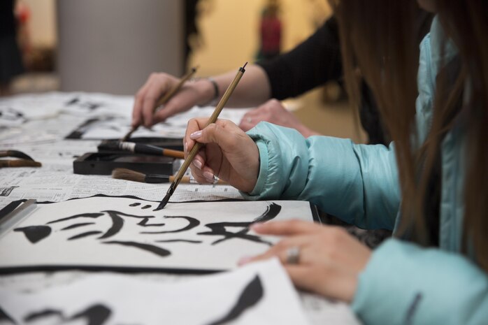 Visitors from School Age Care aboard Marine Corps Air Station Iwakuni, Japan, learned to write Japanese calligraphy dduring the Hina Doll Festival in Shunan City, March 7, 2015. The Hina Doll Festival, or Hinamatsuri, is a day in Japan when parents celebrate their daughters’ happiness, growth and good health and is usually held on March 3.