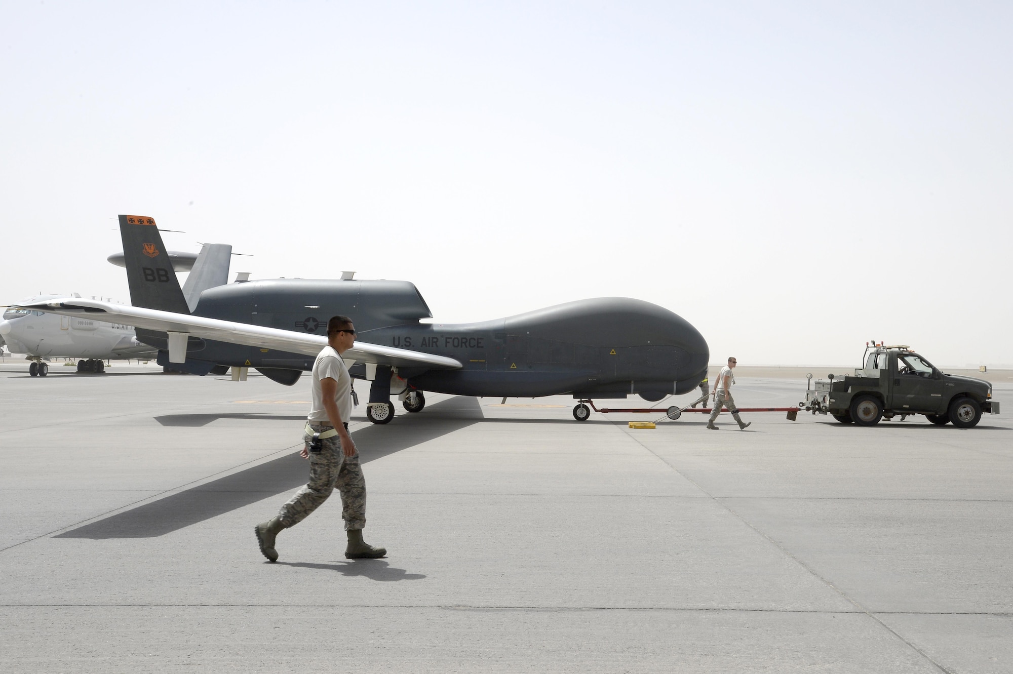 Airmen from Hawk Aircraft Maintenance Unit welcome RQ-4 Global Hawk aircraft 2019 after its 10,000 flying hour milestone flight at an undisclosed location in Southwest Asia Mar. 8, 2015. Block 20s were initially fielded with imagery intelligence (IMINT)-only capabilities. Three Block 20s have been converted to an EQ-4 communication relay configuration, carrying the Battlefield Airborne Communication Node (BACN) payload. (U.S. Air Force photo/Tech. Sgt. Marie Brown)