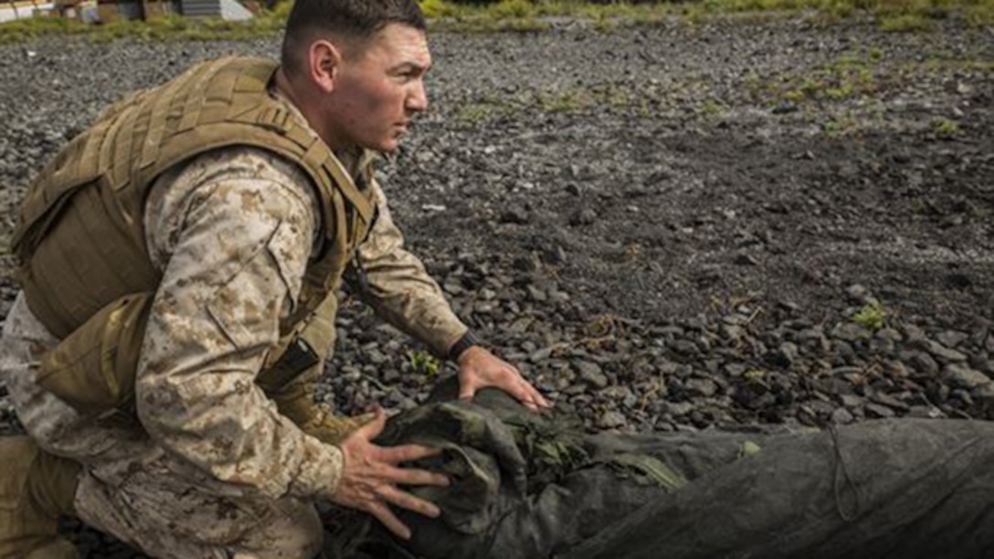 Cpl. Alexander S. Romero rolls up camouflage netting that covers up the forward element’s combat operation center before moving to a new location March 5 during Dragon Fire Exercise 15-2 at Pohakuloa Training Area. The forward element moves to a new location to establish communication before the main element moves in order to execute continuous command and control on the battlefield. Romero, a Lincoln, Nebraska native, is an artillery fire control man with Headquarters Battery, 12th Marine Regiment, 3rd Marine Division, III Marine Expeditionary Force.