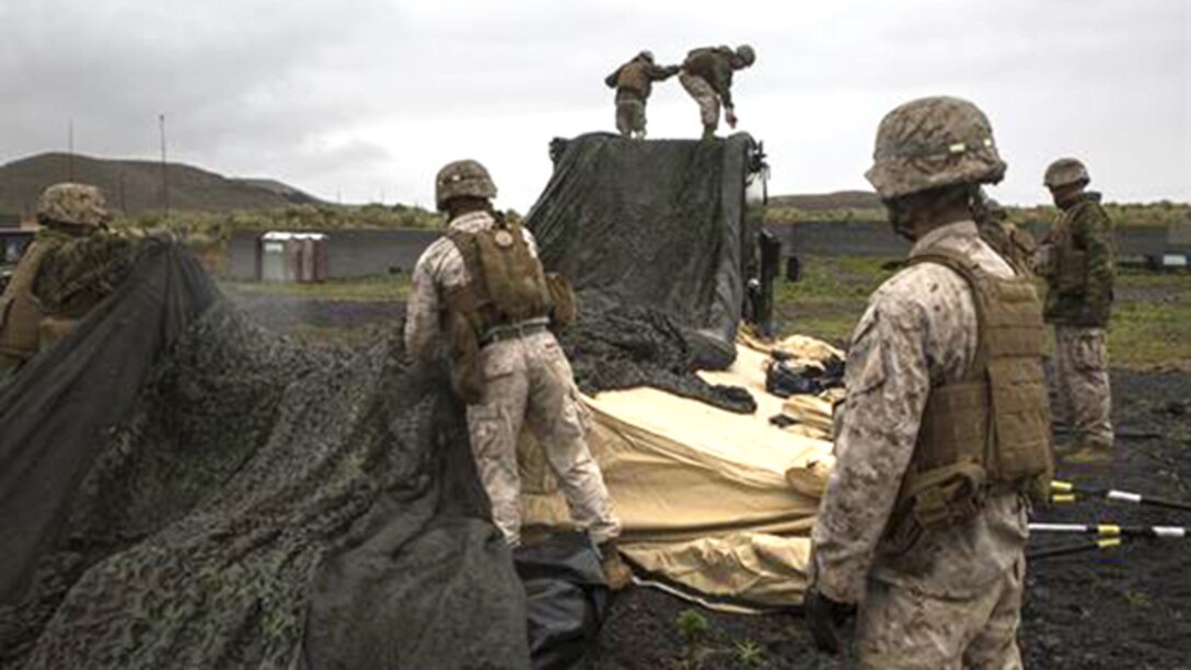 Marines work together to pack up the forward command element, swiftly but diligently, to move it to a new firing point March 5 during Dragon Fire Exercise 15-2 at Pohakuloa Training Area, Kona, Hawaii. “Once the forward is up and is able to control fires and communicate, the main can start packing and jump to where the forward is, that is the close,” said Capt. Robert F. Nicolai. “When they take over the new position, the forward prepares to take a new position.” Nicolai, a Beaverton, Oregon native, is a maintenance management and motor transport officer. Nicolai and the Marines are with Headquarters Battery, 12th Marine Regiment, 3rd Marine Division, III Marine Expeditionary Force.