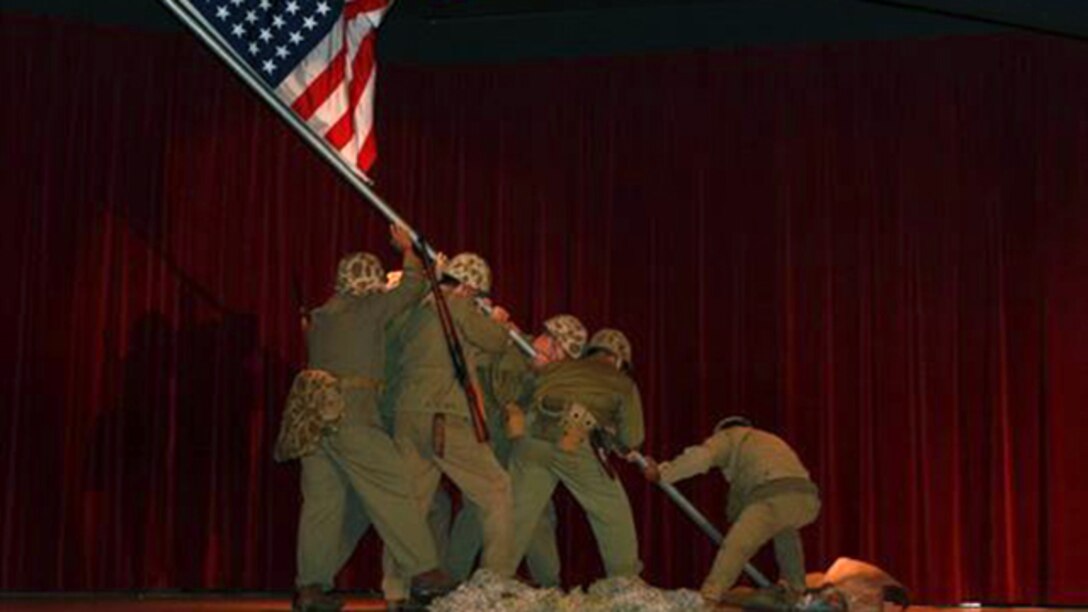 Members of the Marine Corps Historical Company present an Iwo Jima Flag Raising Tableau during the Iwo Jima Commemorative Banquet for the 70th Anniversary of the Battle of Iwo Jima at Marine Corps Base Camp Pendleton, Calif., March 7. The evening included a sunset memorial, 21-gun salute, banquet and a video message for veterans from Commandant of the Marine Corps General Joseph Dunford. “Your legacy is the young men and women who use your example of courage and commitment to inspire them to confront and overcome the challenges that they face today … I pledge that today’s Marines will keep the spirit of Iwo Jima alive,” said Dunford. 