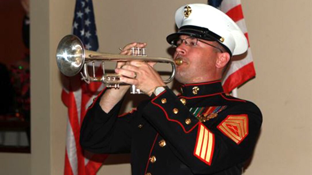 Gunnery Sgt. Michael Flaningam, a trumpet player in the 1st Marine Division Band, I Marine Expeditionary Force, plays taps in memory of fallen Marines during the Iwo Jima Commemorative Banquet for the 70th Anniversary of the Battle of Iwo Jima at Marine Corps Base Camp Pendleton, Calif., March 7. The evening included a sunset memorial, 21-gun salute, banquet and a video message for veterans from Commandant of the Marine Corps General Joseph Dunford. “Your legacy is the young men and women who use your example of courage and commitment to inspire them to confront and overcome the challenges that they face today … I pledge that today’s Marines will keep the spirit of Iwo Jima alive,” said Dunford. 