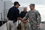 U.S. Army Gen. Frank Grass, the Chief of the National Guard Bureau and a member of the Joint Chiefs of Staff, shakes hands with Dr. David Callaway, the director of the Carolinas MED-1 facility, at the beginning of a tour of the mobile medical unit at Vigilant Guard South Carolina March 9, 2015, at the Georgetown Airport in Georgetown, South Carolina. Vigilant Guard is a series of federally funded disaster-response drills conducted by National Guard units working with federal, state and local emergency management agencies and first responders.