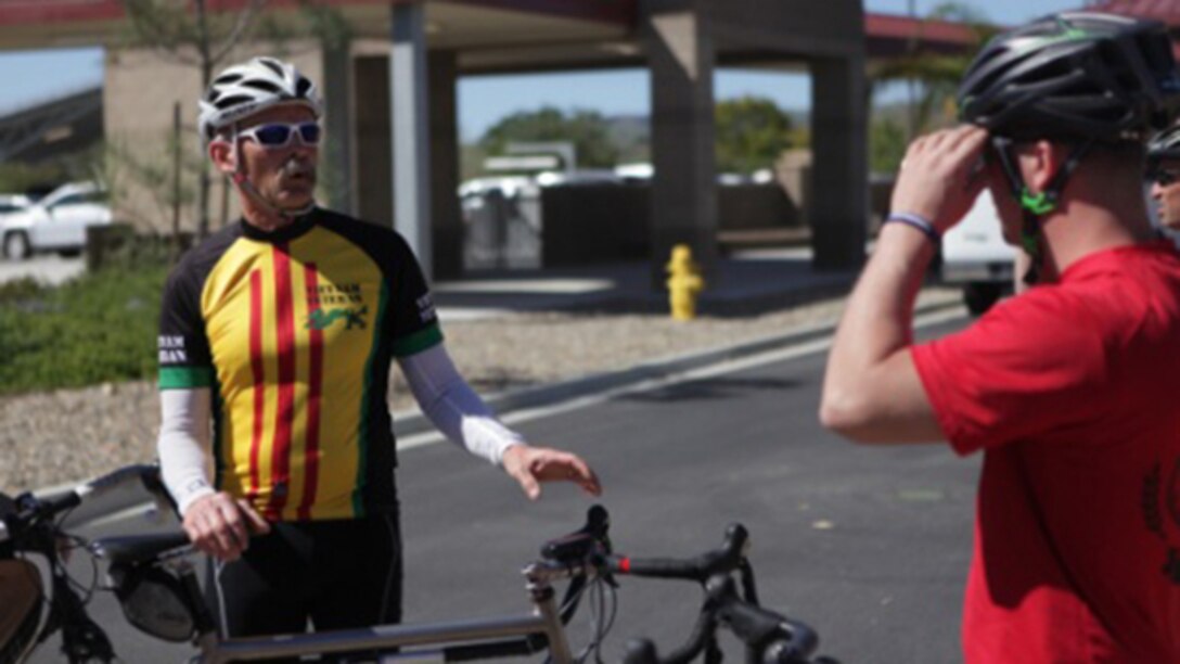 James Panceyres, a cycling coach for the 2015 Marine Corps Trials, speaks to wounded warriors prior to taking them on a bike ride aboard Marine Corps Base Camp Pendleton, California, March 6, 2015. Cycling is one of eight sports that athletes can compete in during the Marine Corps Trials.