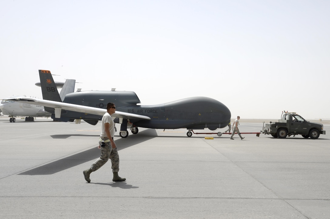 Airmen from an RQ-4B Global Hawk aircraft maintenance unit welcome an RQ-4B after a flight Mar. 8, 2015, in Southwest Asia, in which the aircraft surpassed 10,000 flying hours. The RQ-4B aircraft 2019, or A2019, was the first block 20 and first RQ-4B model to arrive here Oct. 16, 2010. During its service, the aircraft has been providing support to warfighters by relaying communications between people and aircraft as well as enabling airstrikes on the Islamic State of Iraq and the Levant. (U.S. Air Force photo/Tech. Sgt. Marie Brown) 