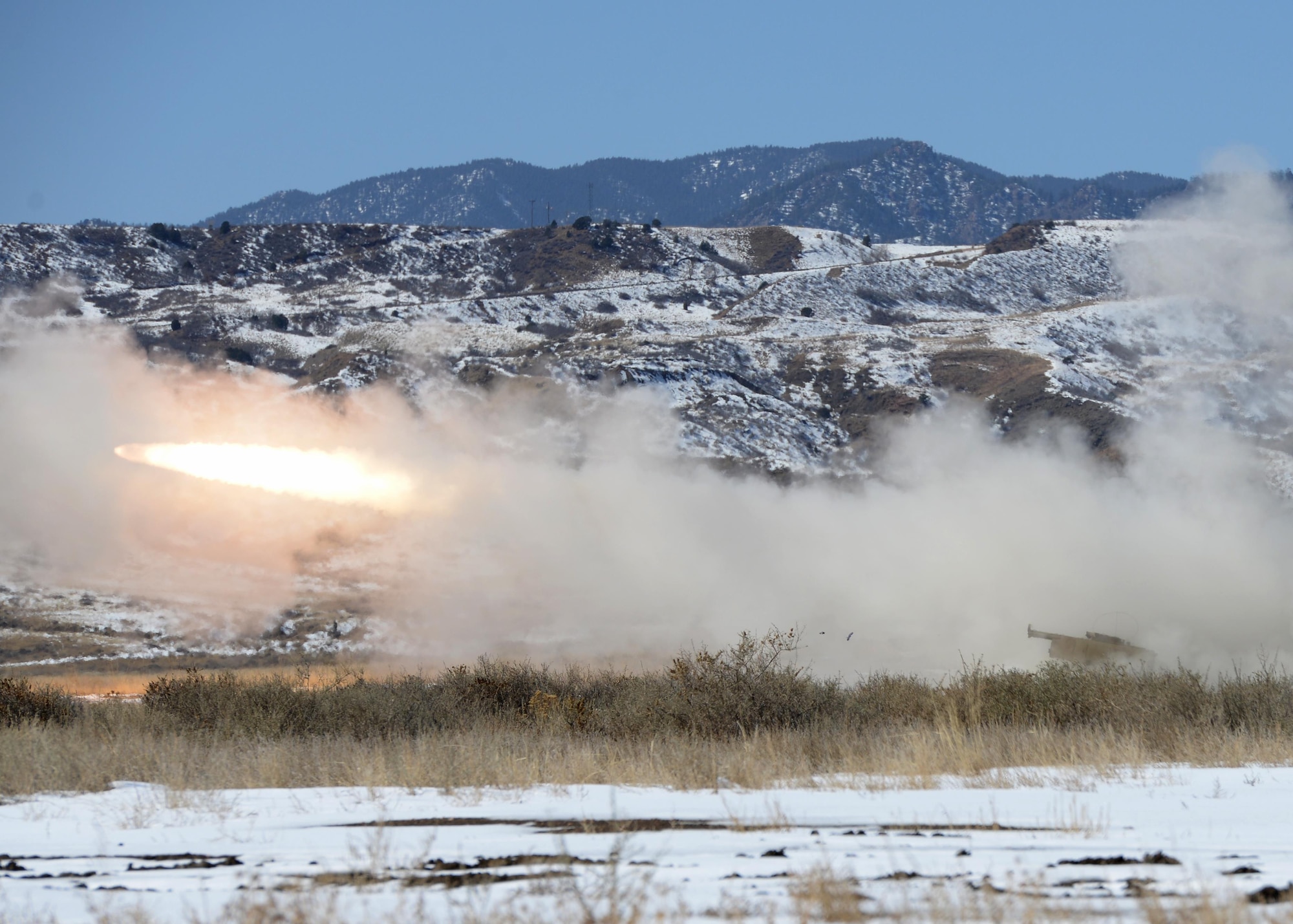 Soldiers fire a rocket from a M142 High Mobility Artillery Rocket System (HIMARS) March 6, 2015, at Fort Carson, Colo. There were 12 rockets fired in total during the joint exercise training. The training helped Airmen and Soldiers stay proficient in transporting, setting up and firing a HIMARS. The Soldiers were from the 1st Battalion, 14 Field Artillery Regiment, 214th Fires Brigade. (U.S. Air Force photo/Airman 1st Class Nathan Clark)