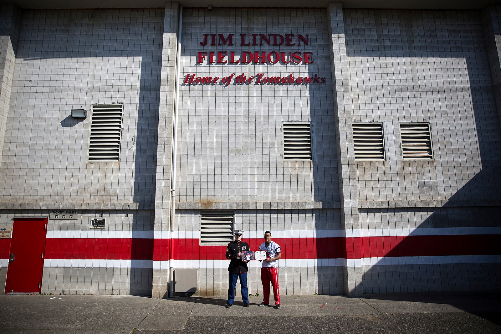 Sgt. Jeff Otterson, a Marine recruiter in Marysville, Washington, congratulates Marysville-Pilchuck High School student athlete Austin Joyner on his participation in the Semper Fidelis All-American Bowl March 9, 2015. Joyner, a highly-touted cornerback from Marysville, was one of three Washington State football players selected to play in the Jan. 4 game in Carson, California. Following his high school graduation, Joyner will attend the University of Washington on an athletic scholarship. (U.S. Marine Corps photo by Sgt. Reece Lodder)