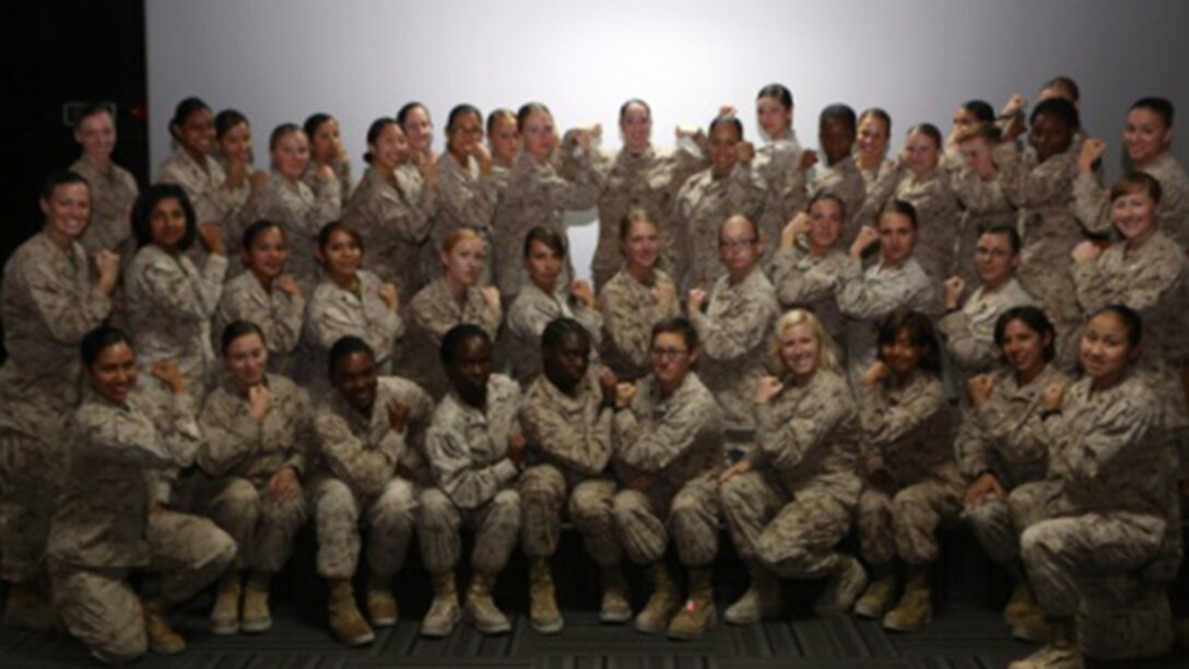 Women Marines assigned to Special Purpose Marine Air Ground Task Force – Crisis Response – Central Command pose for a picture after the Women Marine Symposium, March 2, 2015, in the Central Command area of operations. The symposium was organized to inform the participants about upcoming changes for women Marines, to share the rich history of women in the Corps and to encourage leadership and esprit de corps. 