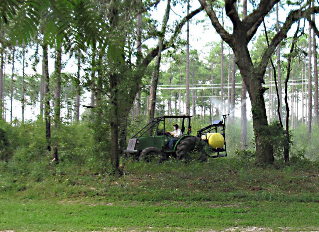 Mark Atwater, contractor, Marine Corps Logistics Base Albany, sprays herbicides to control undesirable vegetation aboard the base, recently.      