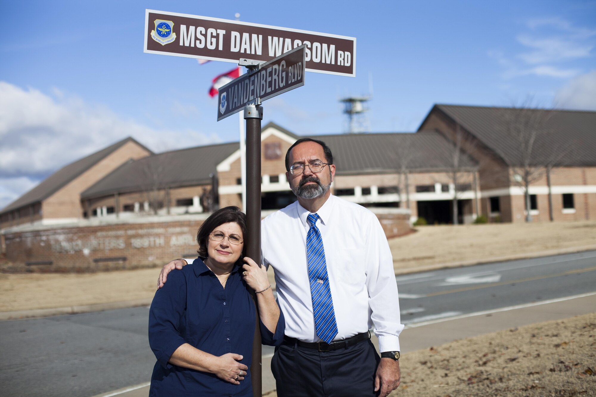Dan Sr. and Pam Wassom stand at the newly designated “MSgt. Dan Wassom Road” at Little Rock AFB, Ark., Dec. 6. The road was named in honor of their son, Master Sgt. Daniel R. Wassom II, or “Bud” as he was called by family and friends. Wassom, a loadmaster evaluator with the 189th Airlift Wing at Little Rock, died April 27 while trying to protect his daughter from a tornado that struck their home in Vilonia, Ark. (U.S. Air Force photo by Senior Airman Ian Caple/Released)