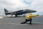 In this file photo, an AV-8B Harrier, assigned to the Marine Attack Squadron 231(VMA), takes off from the flight deck of forward-deployed amphibious assault ship USS Bonhomme Richard (LHD 6). Bonhomme Richard is currently deployed in the U.S. 7th Fleet Area of Operations. 