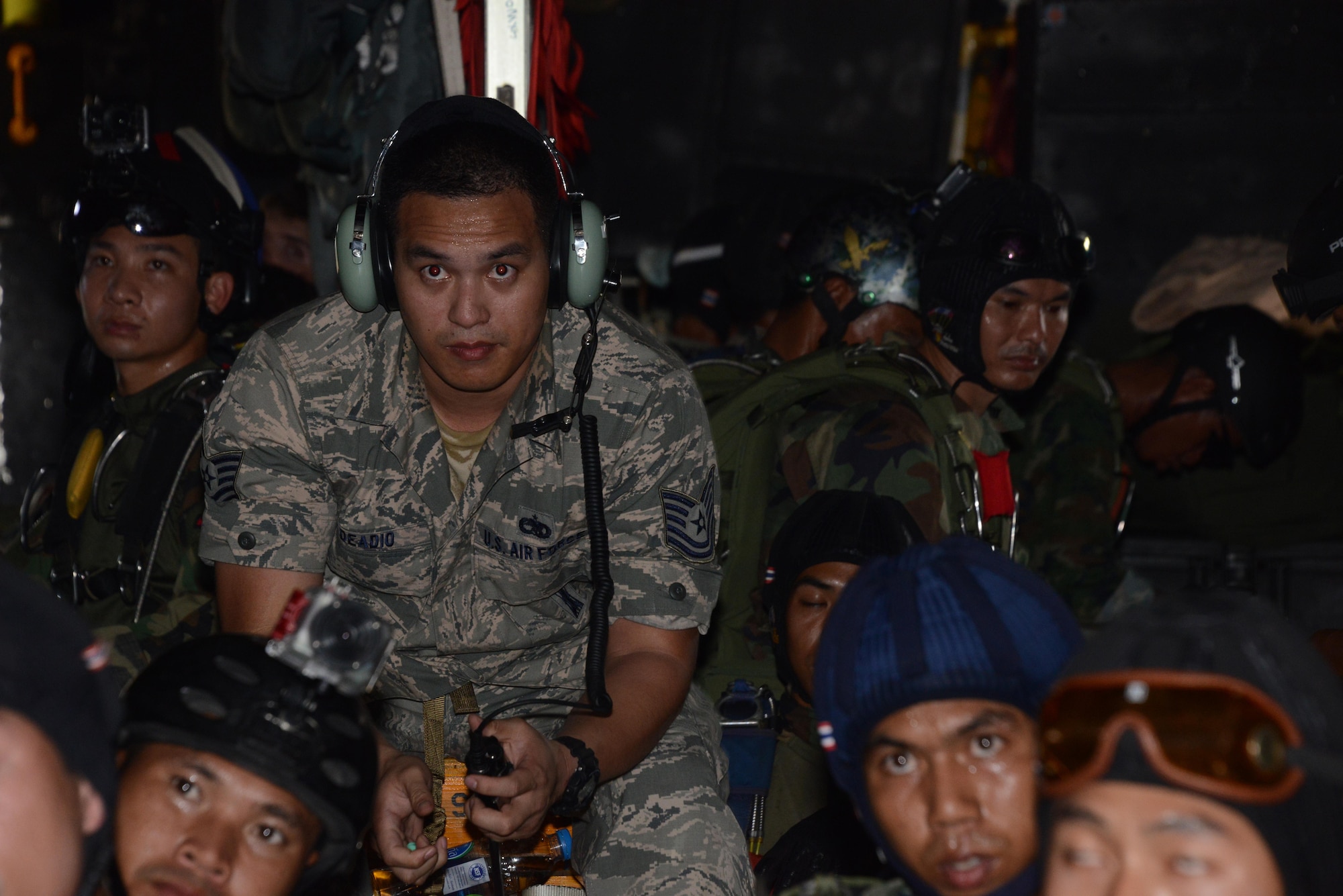 Second from left, Tech. Sgt. Edward Deadio, 31st Munitions Squadron, helps translate between the U.S. military and the Thai military during a jump briefing Feb. 16, 2015.  Deadio, a native Thai speaker and participant in the Language Enabled Airman Program, was sent to Cobra Gold 15-1 to provide language support for the 353rd Special Operations Group.  During the 2-week exercise, Deadio helped bridge the language and culture gap between U. S. and Thai military.   (U.S. Air Force photo by Tech. Sgt. Kristine Dreyer)