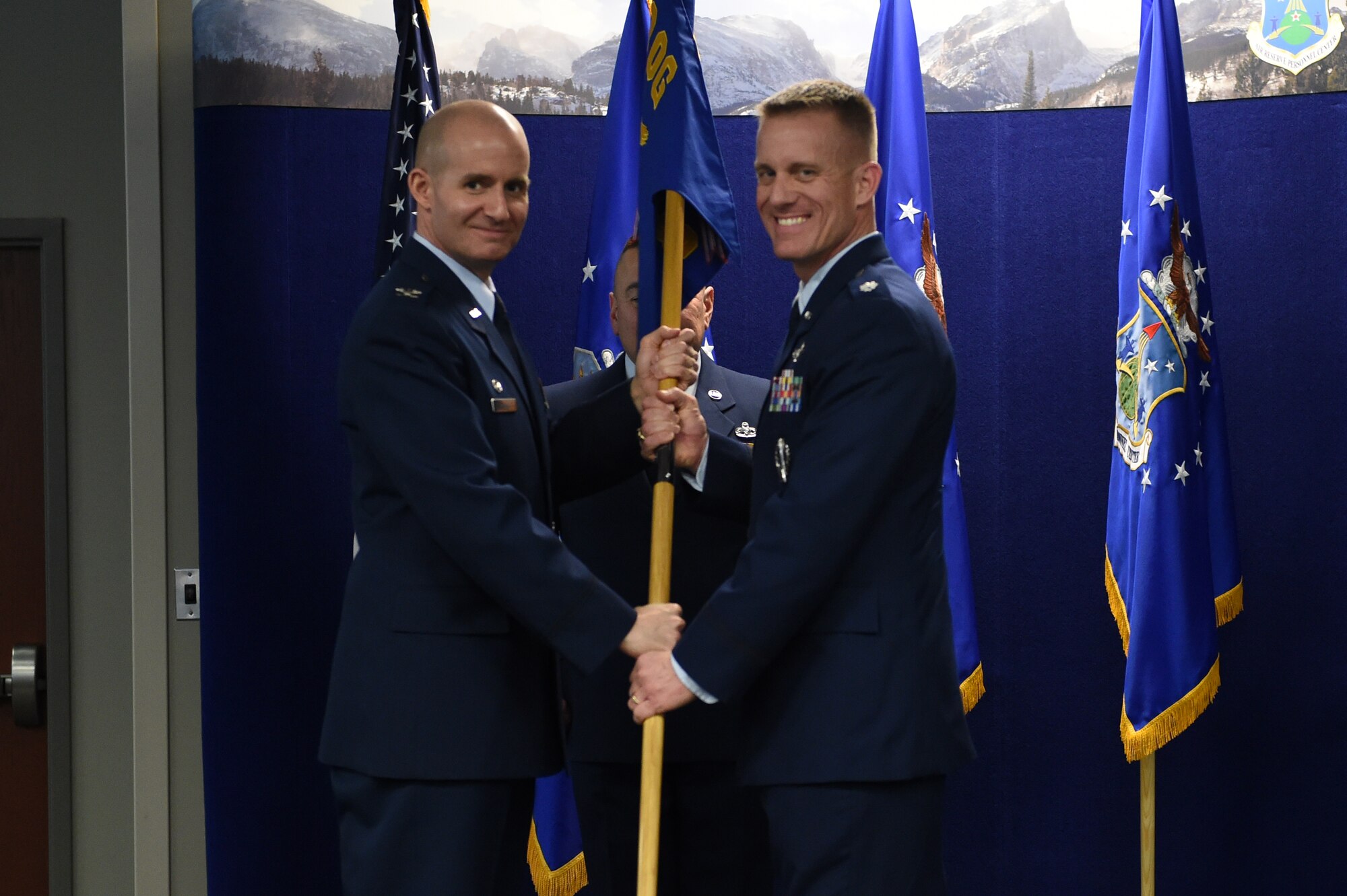 Col. Michael Assid, 310th Operations Group commander, left, presents the 8th Space Warning Squadron guidon to Lt. Col. Keith Jansa, 8 SWS commander, right, signifying his assumption of command March 8, 2015, at the Air Reserve Personnel Center on Buckley Air Force Base, Colo. During the ceremony, Jansa assumed command from Lt. Col. Nathan Yates after two years of service to the unit. (U.S. Air Force photo by Airman 1st Class Emily E. Amyotte/Released)