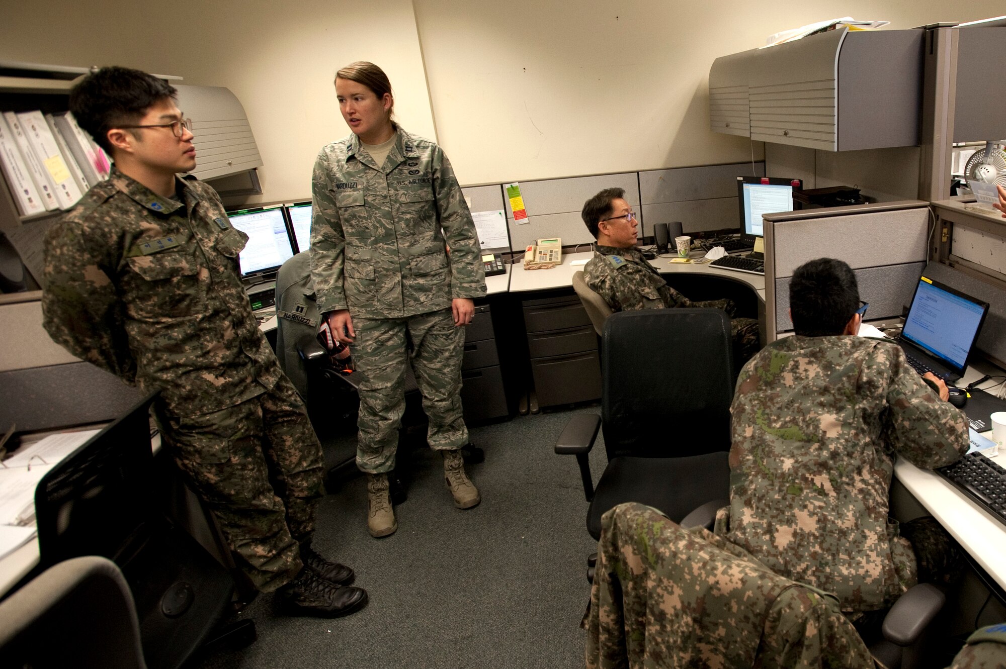 Republic of Korea (ROK) air force 2nd Lt. Suk Hyenn Lee, an interpreter, and U.S. Air Force Capt. Anna Narduzzi, the Seventh Air Force plans and readiness chief, discuss exercise Key Resolve civil engineer plans March 10, 2015, on Osan Air Base, Republic of Korea. Key Resolve is directed at maintaining the readiness of the Combined Forces Command staff and components. It is executed in conjunction with exercise Foal Eagle and involves more than 29,000 U.S. forces and more than 200,000 ROK forces. (U.S. Air Force photo by William Banton)