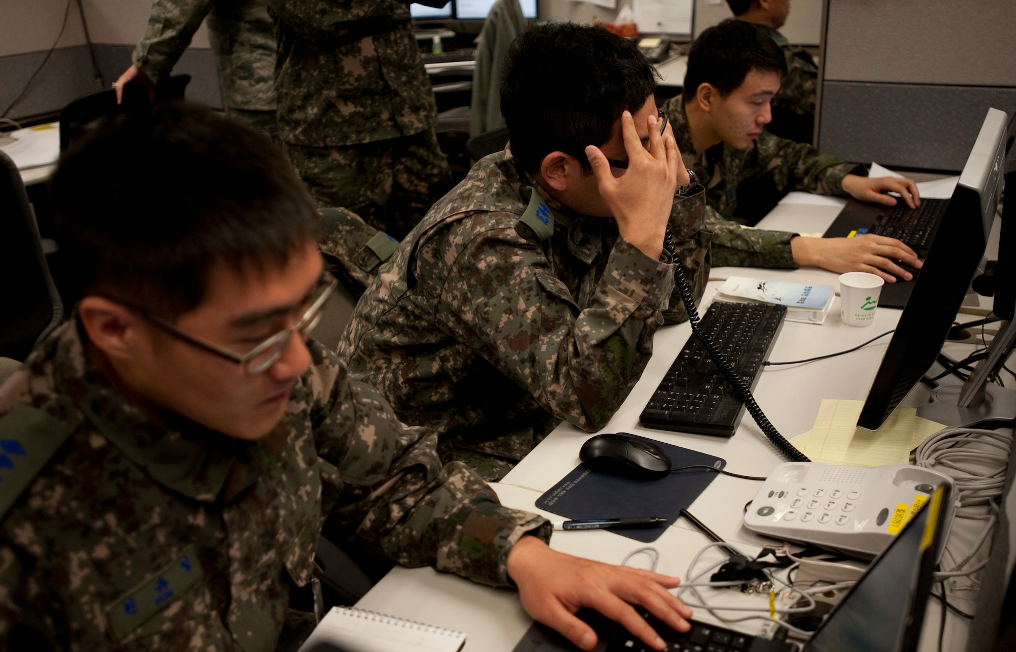 Members of the Republic of Korea air force gather information March 10, 2015, during Key Resolve on Osan Air Base, Republic of Korea. The civil engineers' primary mission during exercise Key Resolve is to repair damage that would occur during an attack as fast as possible to continue operations. (U.S. Air Force photo by William Banton)