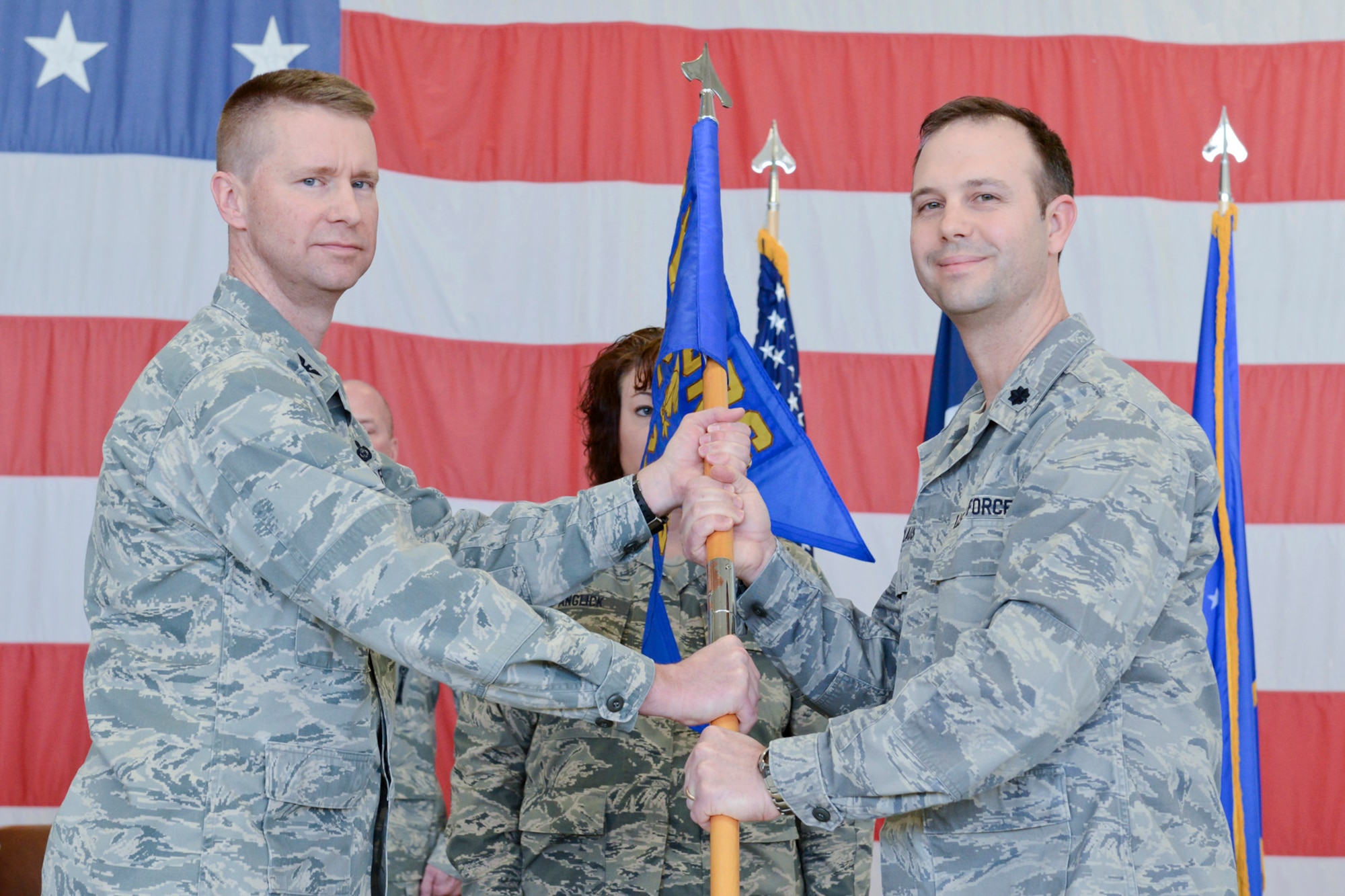 Col. Mark Chidley (left), 132d Wing (132WG), Des Moines, Iowa  Intelligence Surveillance Reconnaissance Group (ISRG) Commander, passes the 232d Intelligence Squadron (232 IS) guidon to Lt. Col. Brian Claus (right), 232 IS Commander, during the 132WG ISRG Activation Ceremony held in the 132WG Fire House on Saturday, March 7, 2015.  This ceremony formally recognizes the official activation of the 132WG ISRG.  (U.S. Air National Guard photo by Staff Sgt. Linda K. Burger/Released)