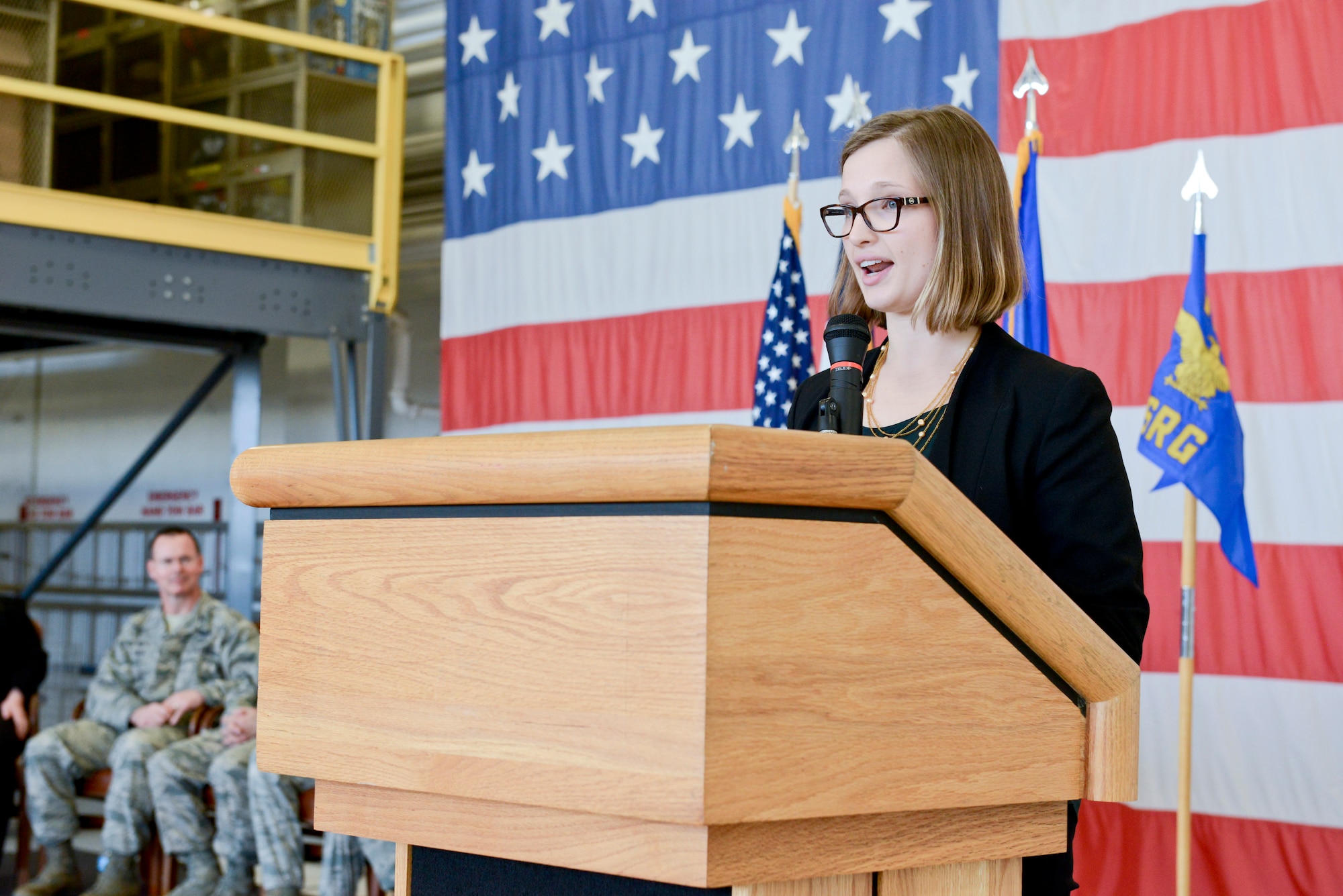 Amelia Schoeneman (standing at podium), representing Congressman Dave Loebsack, speaks to members of the 132d Wing (132WG), Des Moines, Iowa Intelligence Surveillance Reconnaissance Group (ISRG) during the 132WG ISRG Activation Ceremony held in the 132WG Fire House on Saturday, March 7, 2015.  This ceremony formally recognizes the official activation of the 132WG ISRG.  (U.S. Air National Guard photo by Staff Sgt. Linda K. Burger/Released)