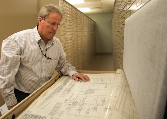 Mike Miller, the drafting lead with the 96th Civil Engineer Group’s Engineering Division, reviews a hardcopy drawing in the division’s vault at Eglin Air Force Base, Fla. The drafting division works with project engineers and inspectors to create the drawings needed for construction projects across base. Upon completion, all drawings are stored in a hardcopy vault that currently holds more than 70,000 drawings. (U.S. Air Force photo/Ilka Cole)  