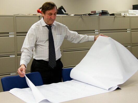 Steve Daugherty, lead for the 96th Civil Engineer Group’s Simplified Acquisition of Base Engineer Requirement program, pours over a drafting document for a new construction project at Eglin Air Force Base, Fla. SABER is responsible for issuing out construction projects that range from $2,000 to $1 million. By using one contractor for a more streamlined process, this 10-person office completes 100-150 construction projects every year.  (U.S. Air Force photo/Ilka Cole)  