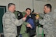 Tech. Sgt. John Hurley and Staff Sgt. Joseph Coates, 177th Fighter Wing Explosive Ordinance Disposal, assist a member of a youth advisory council with the donning of a bomb suit during a tour on March 7, 2015 at the Atlantic City Air National Guard base. . (U.S. Air National Guard photo by Tech. Sgt. Andrew J. Merlock Jr./Released)