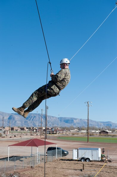 Marine Corps Sgt. Maj. Bryan B. Battaglia, Senior Enlisted Advisor to the Chairman of the Joint Chiefs of Staff, is hoisted to the top of a 40-foot giant swing at the Holloman ropes course, Holloman Air Force Base, N.M. March 6. The ropes course is used during resilience training to teach Airmen to recognize stress responses and engage with those responses constructively to enable critical thinking under stress. Prior to speaking at the 2015 Chief Master Sgt. Induction ceremony, Battaglia visited with Airmen and received Holloman mission briefings. (U.S. Air Force photo by Airman 1st Class Emily A. Kenney/Released)