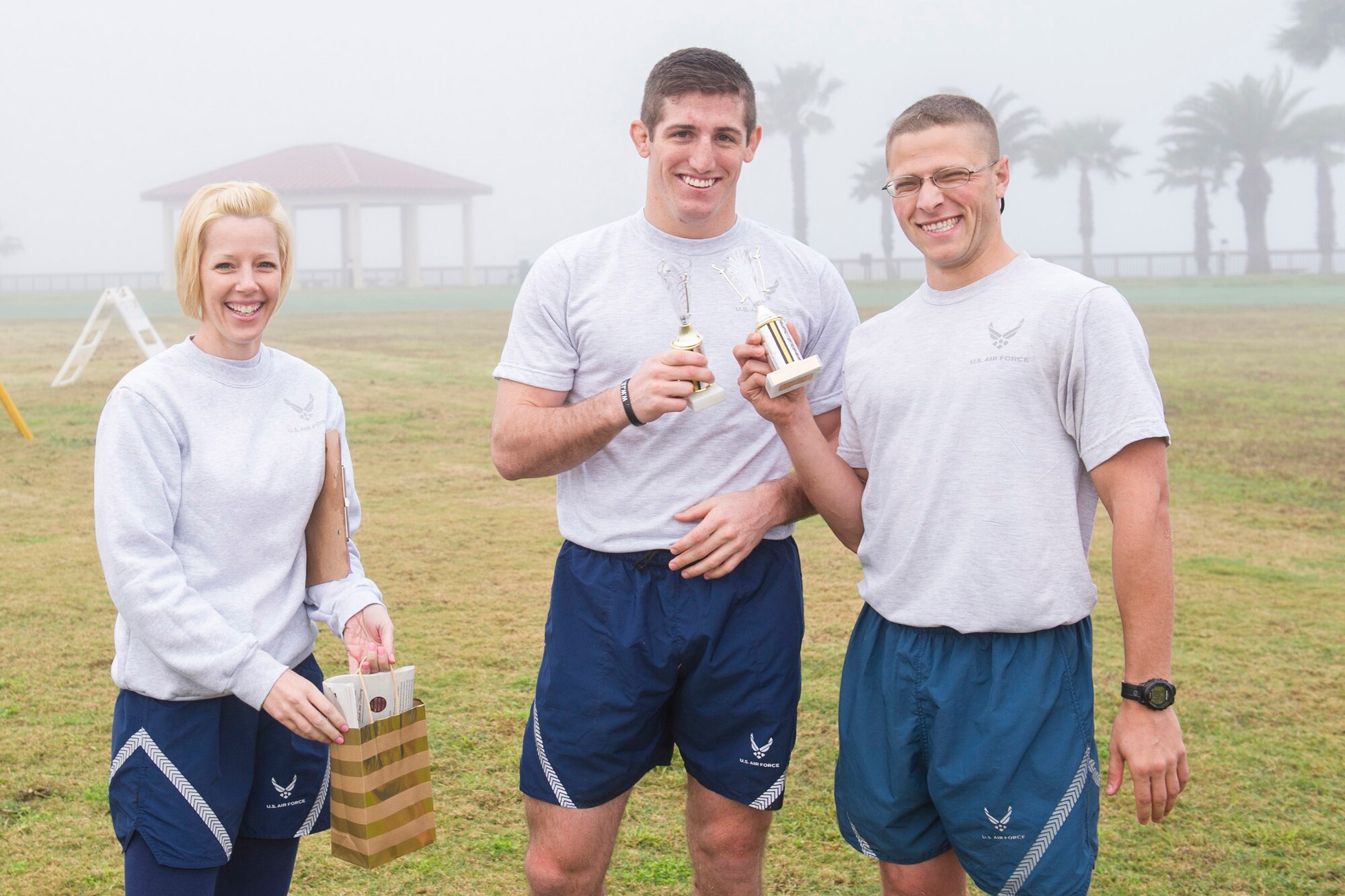The winners of the Women’s History Month Obstacle Course, 2nd Lt. Charles Hohnbaum and 2nd Lt. Joshua Kreimier, both from the 5th Launch Support Squadron, hold up their awards as Master Sgt. Stacy Lindsey, 45th Space Wing first sergeant and organizer for the event, pose with them March 2, 2015, at Warfit Field on Patrick Air Force Base. (U.S. Air Force photo/Matthew Jurgens)